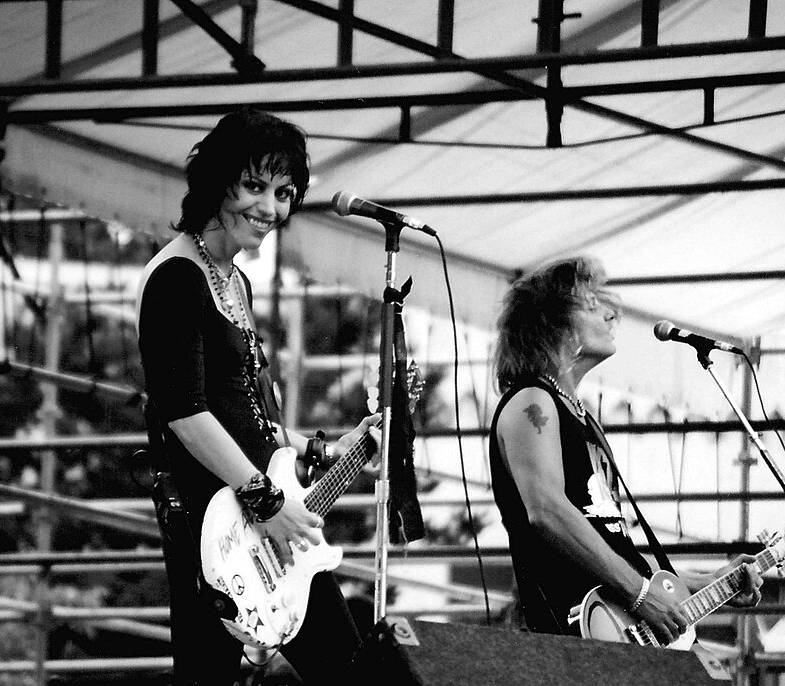 Joan Jett smiling on stage with her guitar, Bumbershoot, Seattle, 1994