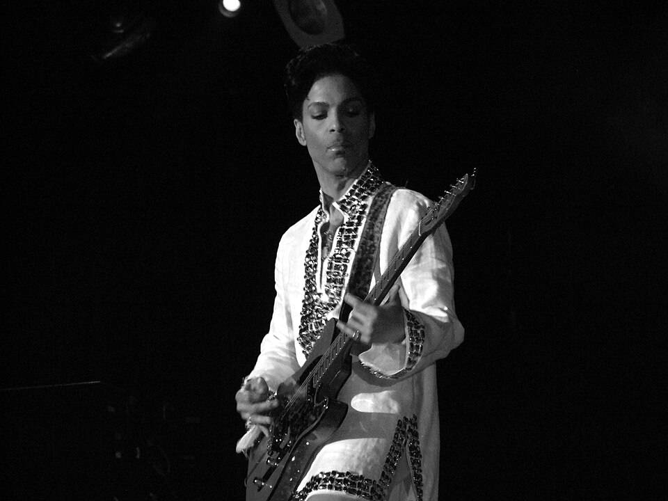 Prince playing guitar on stage at Coachella, 2008
